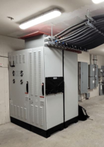 SmartGATE installed in a plant room with feeder conduit routed overhead into the top of the unit